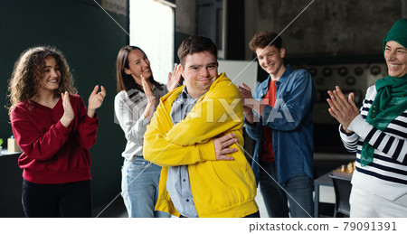 Down syndrome man with friends in community center, inclusivity and unity concept. 79091391