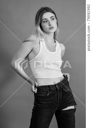 woman in torn jeans woman in torn jeans 79092992