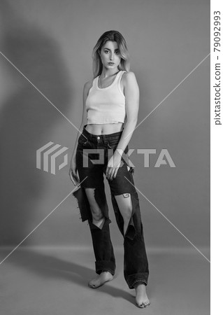 woman in torn jeans woman in torn jeans 79092993
