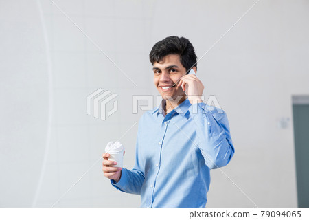 young businessman talking on his cell phone young businessman talking on his cell phone 79094065