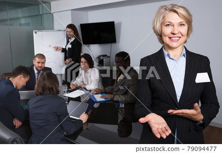 Woman with team in boardroom Woman with team in boardroom 79094477