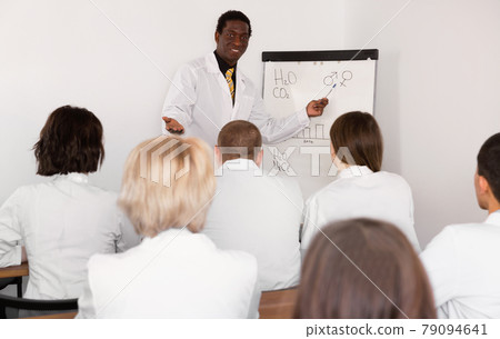 Smiling African American male professor giving presentation for medics 79094641