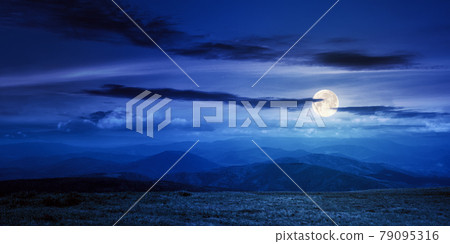 mountain meadow at night. beautiful landscape with clouds above horizon in full moon light. wonderful nature background mountain meadow at night. beautiful landscape with clouds above horizon in full moon light. wonderful nature background 79095316