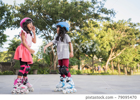 asian girl going on her in-line skates asian girl going on her in-line skates 79095470