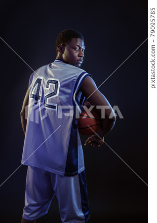 Basketball player with ball, black background 79095785