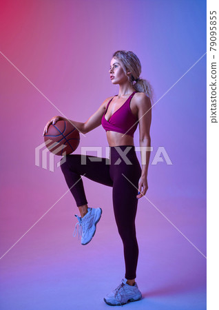 Young sportswoman with ball poses in studio 79095855