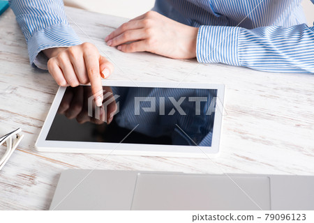 Business lady using tablet computer at desk Business lady using tablet computer at desk 79096123