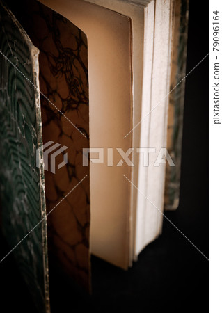 Old book on black background Old book on black background 79096164