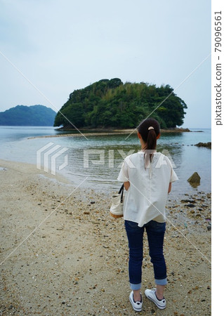 A woman walking on the road connecting Suooshima and the love power spot Shingujima A woman walking on the road connecting Suooshima and the love power spot Shingujima 79096561