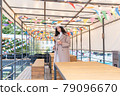 Woman with coffee on the veranda 79096670