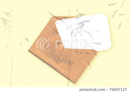 Natural light casts shadows from the plant on an envelope with a sheet of white paper lying on a yellow textured background. Mockup Natural light casts shadows from the plant on an envelope with a sheet of white paper lying on a yellow textured background. Mockup 79097127
