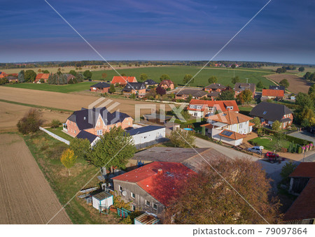 Aerial view of the edge of a settlement with a large shed Aerial view of the edge of a settlement with a large shed 79097864