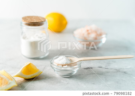 Eco friendly natural cleaners, jar with baking soda, lemon, pink salt and wooden spoon on marble table background. Organic ingredients for homemade cleaning. Zero waste concept Eco friendly natural cleaners, jar with baking soda, lemon, pink salt and wooden spoon on marble table background. Organic ingredients for homemade cleaning. Zero waste concept 79098182