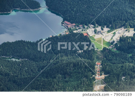 Valley station of a cable car to the Zugspitze in the Bavarian Alps with the part of a large mountain lake 79098189