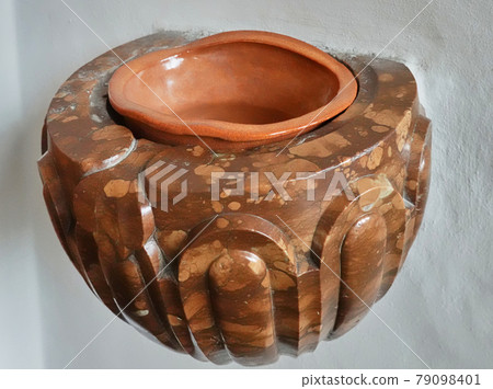 Holy water bowl made of marble with a remnant of water consecrated by the priest Holy water bowl made of marble with a remnant of water consecrated by the priest 79098401