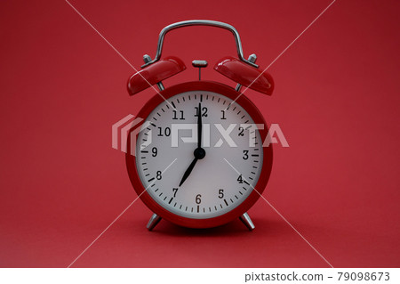 Closeup of alarm clock on red background Closeup of alarm clock on red background 79098673