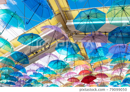Bright rainy season image photo with many umbrellas hung from the ceiling 79099050