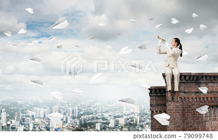 Young woman playing trumpet and sitting on roof Young woman playing trumpet and sitting on roof 79099748