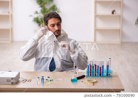 Young male chemist working at the lab during pandemic Young male chemist working at the lab during pandemic 79100090