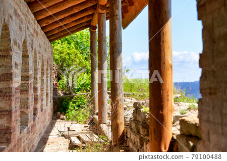 Fragment of the old fortress wall with windows overlooking the sea coast Fragment of the old fortress wall with windows overlooking the sea coast 79100488
