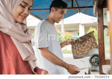 man and woman street food seller 79100553