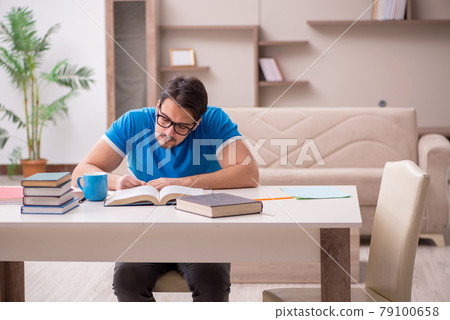 Young male student studying at home Young male student studying at home 79100658