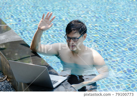 Asian man communication via internet with laptop computer in swimming pool lifestyle travel. Asian man communication via internet with laptop computer in swimming pool lifestyle travel. 79100773
