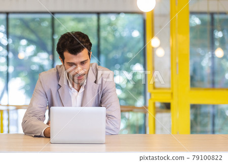 handsome businessman working with laptop at workplace. online conference corporate. 79100822