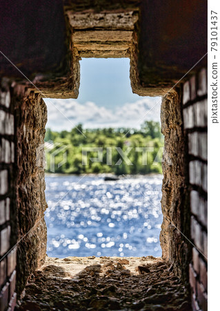 Observation window in the brick wall of the fortress for firing a gun with Observation window in the brick wall of the fortress for firing a gun with 79101437