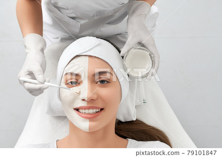 Attractive woman doing procedure for rejuvenation in salon. Attractive woman doing procedure for rejuvenation in salon. 79101847