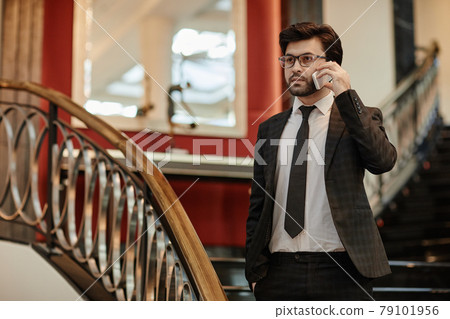 Businessman Speaking by Smartphone in Hotel 79101956