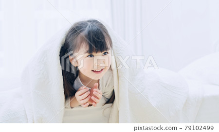 Girl hiding in sheets Girl hiding in sheets 79102499