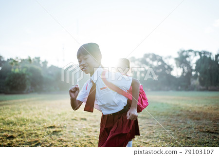little girl student running together while going to their school little girl student running together while going to their school 79103107