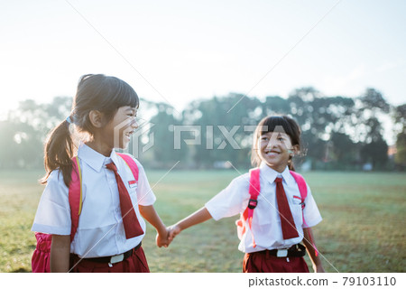 primary school student friend wearing indonesian uniform going to school primary school student friend wearing indonesian uniform going to school 79103110