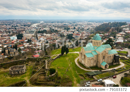 View from drone of Bagrati Cathedral in Kutaisi against cityscape 79103372