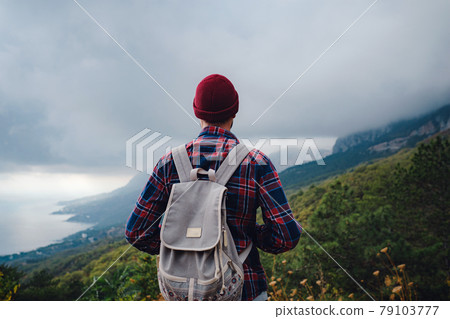 Man traveling with a backpack hiking in the mountains travel. Man traveling with a backpack hiking in the mountains travel. 79103777