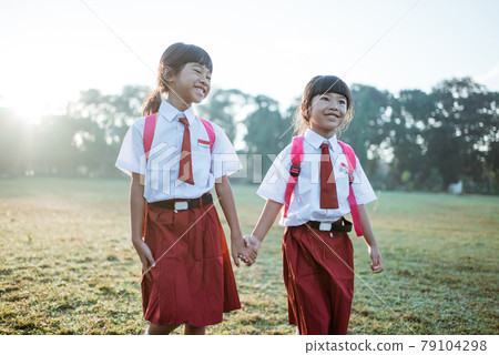 happy female asian primary school student walk together happy female asian primary school student walk together 79104298