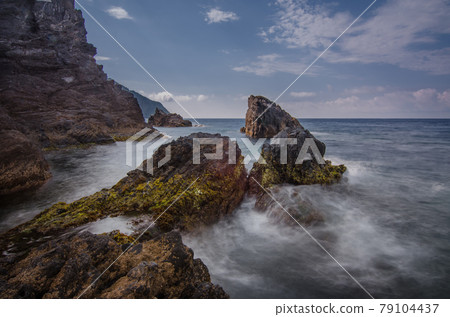 Rocks and waves on the sea near Cinque Terre - Manarola, picturesque fishermen villages in the province of La Spezia, Liguria, Italy 79104437