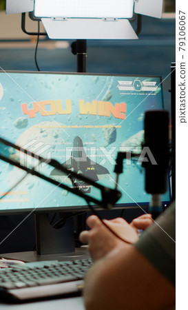 Entusiastic man gamer streamer wining space shooter video games 79106067