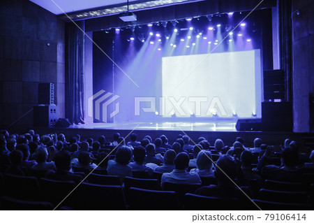 People are waiting for the speaker to speak, empty stage. Focus on the stage. blue toning photo People are waiting for the speaker to speak, empty stage. Focus on the stage. blue toning photo 79106414