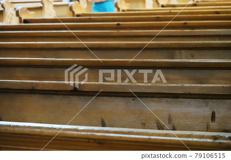 Empty wooden benches in a catholic church Empty wooden benches in a catholic church 79106515