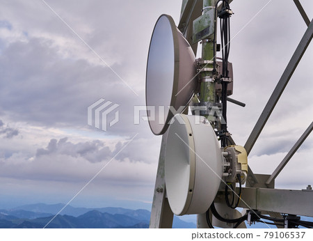 Satellite dishes on a mast on a high mountain in the Alps Satellite dishes on a mast on a high mountain in the Alps 79106537