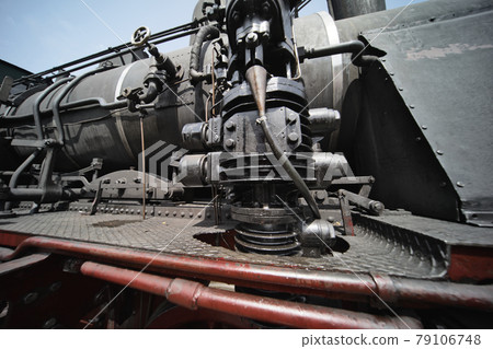 Black hydraulic brake cylinder of a historic locomotive Black hydraulic brake cylinder of a historic locomotive 79106748