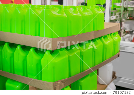 Stacks of many empty green plastic jerrycans 79107182