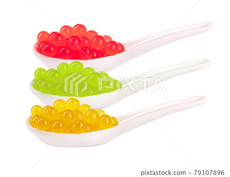 Tapioca pearls for bubble tea isolated on white background. Mix tapioca fruit pearls in spoon. 79107896