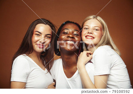 diverse multi nation girls group, teenage friends company cheerful having fun, happy smiling, cute posing on yellow background, lifestyle people concept, african-american, asian and caucasian diverse multi nation girls group, teenage friends company cheerful having fun, happy smiling, cute posing on yellow background, lifestyle people concept, african-american, asian and caucasian 79108592