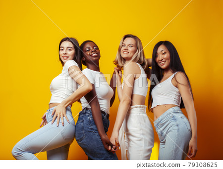 diverse multi nation girls group, teenage friends company cheerful having fun, happy smiling, cute posing on yellow background, lifestyle people concept, african-american, asian and caucasian diverse multi nation girls group, teenage friends company cheerful having fun, happy smiling, cute posing on yellow background, lifestyle people concept, african-american, asian and caucasian 79108625