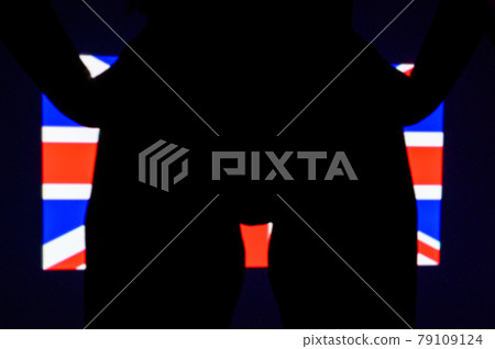 The projection of the flag of the United kingdon on a beautiful large female ass. The projector shines with a flag of the England on a female body. British The projection of the flag of the United kingdon on a beautiful large female ass. The projector shines with a flag of the England on a female body. British 79109124