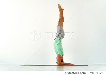 Young man acrobatics gymnastic doing a handstand studio isolated on white background, athletic sportsman Young man acrobatics gymnastic doing a handstand studio isolated on white background, athletic sportsman 79109125