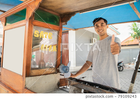 man street food seller of chicken satay with food cart selling sate ayam. man street food seller of chicken satay with food cart selling sate ayam. 79109243